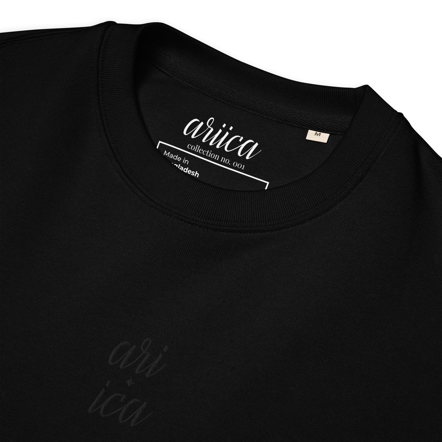 Close-up of the black Organic Sweatshirt with detailed black split Embroidery, highlighting the intricate stitching and luxurious fabric.