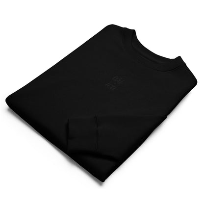 Folded Black Organic Sweatshirt with black spilt Embroidery, featuring minimalist luxury and sustainable craftsmanship.