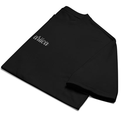 Folded Oversized Black Heavyweight Tee with white Embroidery, emphasizing minimalist design and high-quality fabric