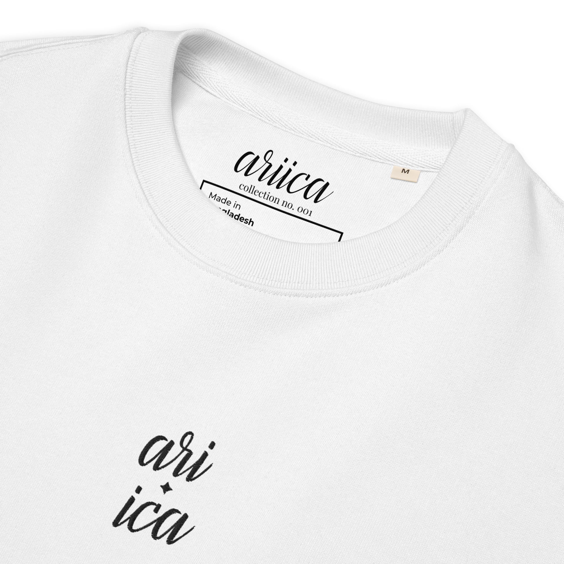 Close-up of the white Organic Sweatshirt with detailed black split Embroidery, highlighting the intricate stitching and luxurious fabric.