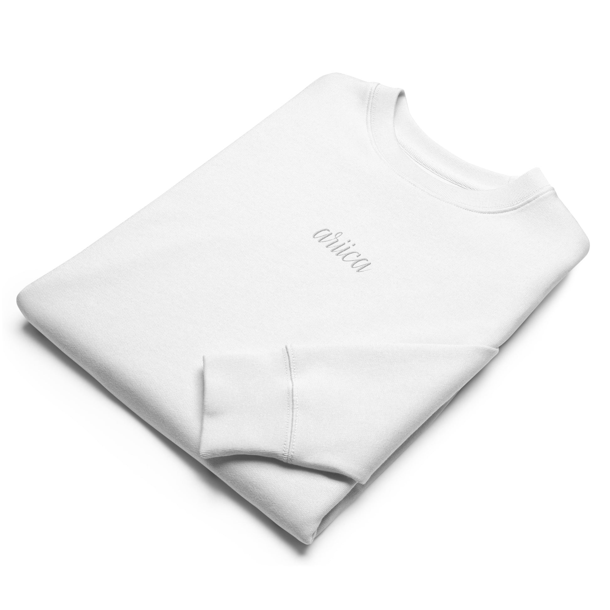 Folded White Organic Sweatshirt with white Embroidery, featuring minimalist luxury and sustainable craftsmanship.