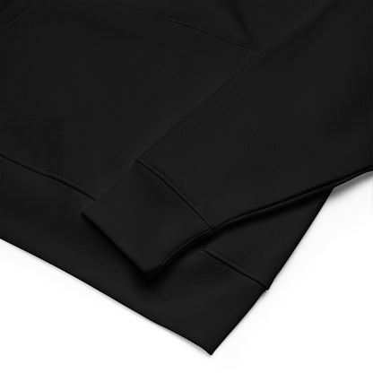 Close-up of the Black Premium Essential Hoodie, showcasing the sleeve and bottom hem with delicate black embroidery.