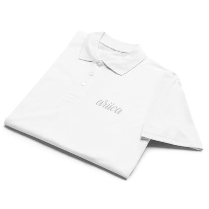 White Premium Polo Shirt with white embroidery, neatly folded to showcase its soft fabric and refined design.